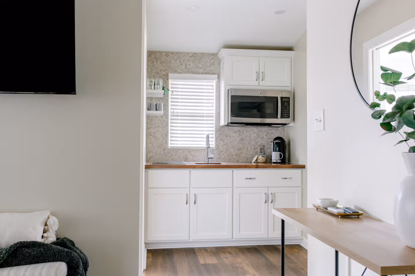 Modern kitchenette with Wolf cooktop and dining space